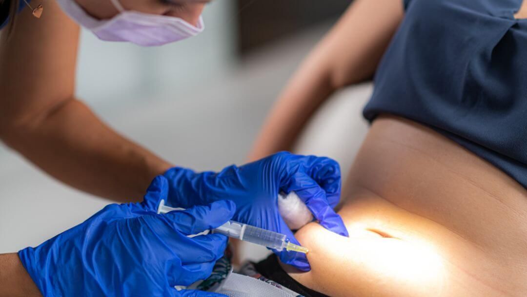 A gloved clinician administers an injection to a patient's abdomen at the medical spa at Rapid Weight Loss Centers in the Pee Dee and Grand Strand region of South Carolina.